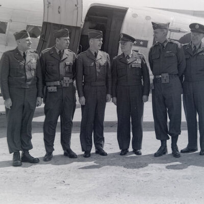 Generals Styron, Muldrow, Allen and others standing next to a transport aircraft