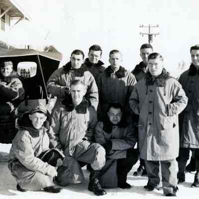 Group of soldiers posing in front of a Jeep