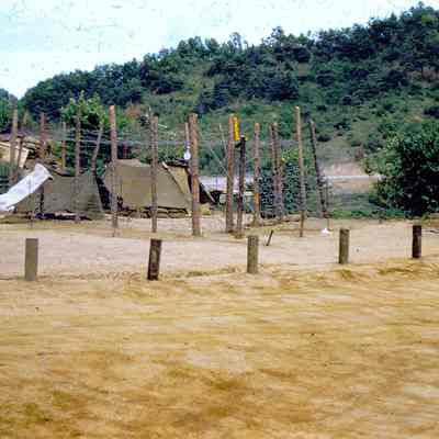 Soldier standing guard of a makeshift stockade for prisoners of war