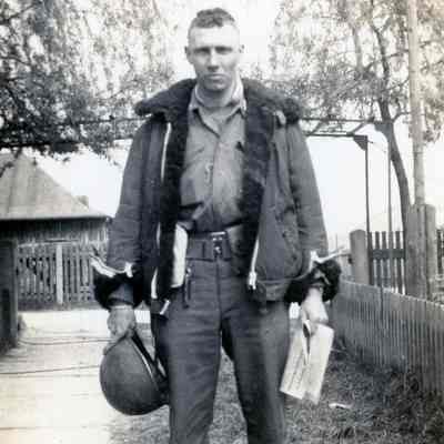Officer holding his helmet and newspaper
