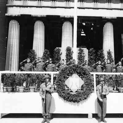 Officers saluting on podium