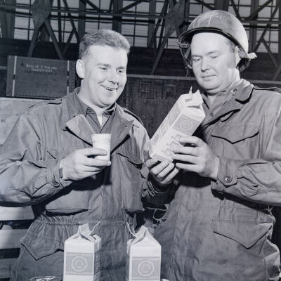 Two soldiers examining milk cartons