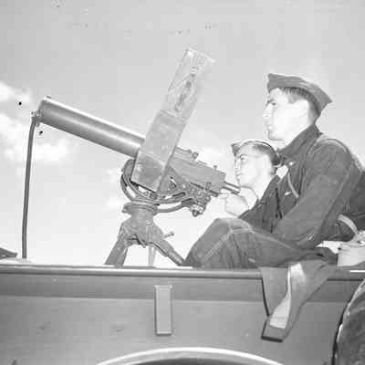 Soldiers sitting with a truck-mounted machine gun