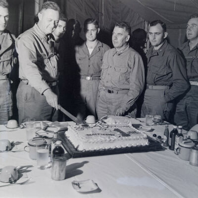 General Styron cutting a cake in a mess tent