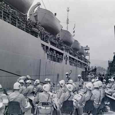 45th Division Band at dockside playing for troops onboard a ship