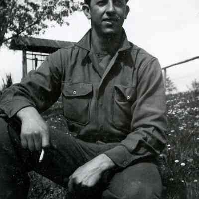 Soldier kneeling in field