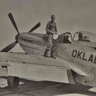 Pilot stands on the wing of his P-51