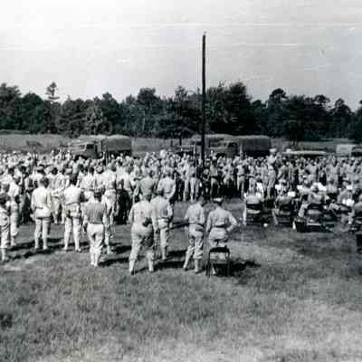 Soldiers gathered listening to a band