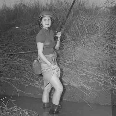 Girl wearing a helmet and holding a rifle