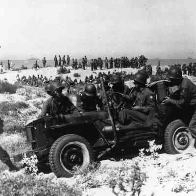 Soldiers pushing Jeep