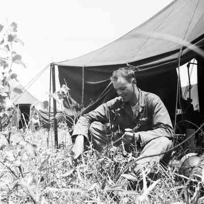 Soldier sitting in front of a tent