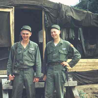 Two soldiers posing in front of a tent