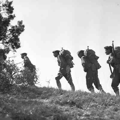 Soldiers marching up a hill