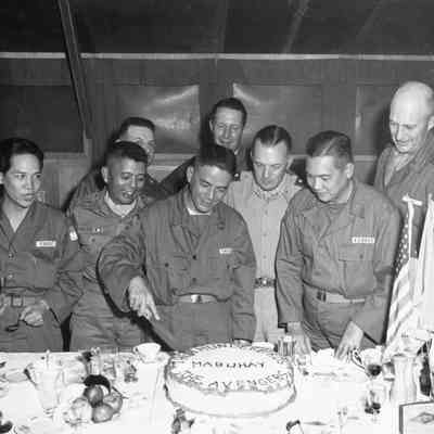 Soldiers watch a cake being cut