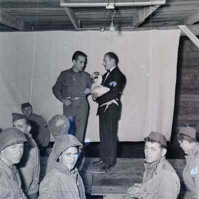 Humphrey Bogart and another entertainer on a makeshift stage