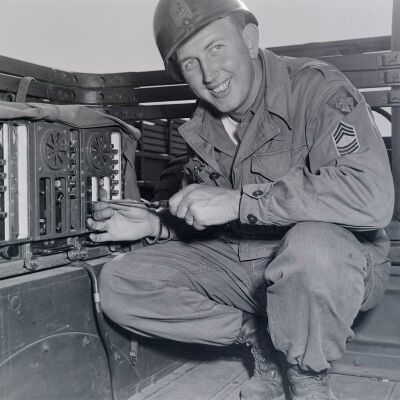 Soldier repairing communication gear