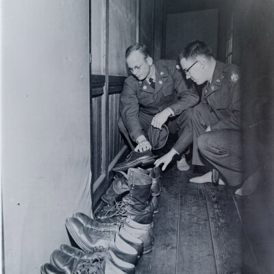 Soldiers search for their shoes outside a Japanese home