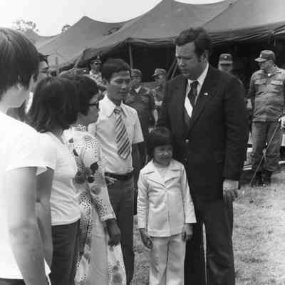 Govenor David Boren meeting a refugee family from Vietnam