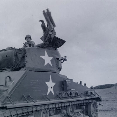 Tank with two soldiers sitting in the turret