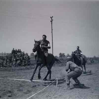 Soldiers racing horses