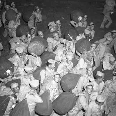 Soldiers carrying duffle bags