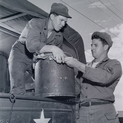Soldiers loading cargo into truck