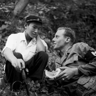 Japanese boy and soldier sharing a melon