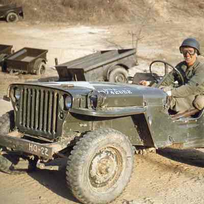Soldier wearing goggles in a jeep