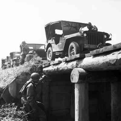 Soldier checking bridge structure before jeep crossing