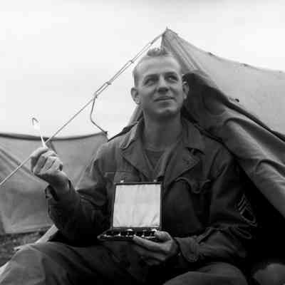 Soldier displaying boxed silverware set