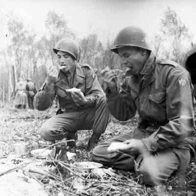 Soldiers eating along the roadside