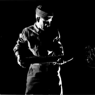 Soldier loading shell into artillery piece