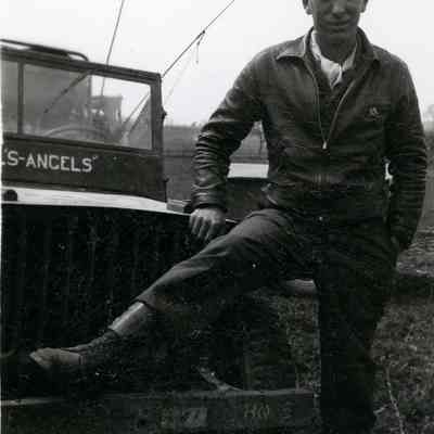 Soldier posing with a jeep