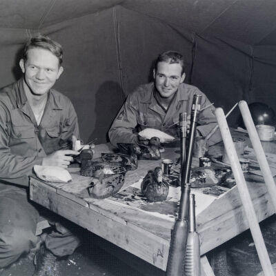 Soldiers in a tent making duck decoys