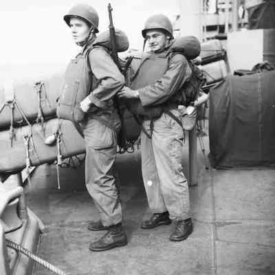 Soldiers checking each other's life vests