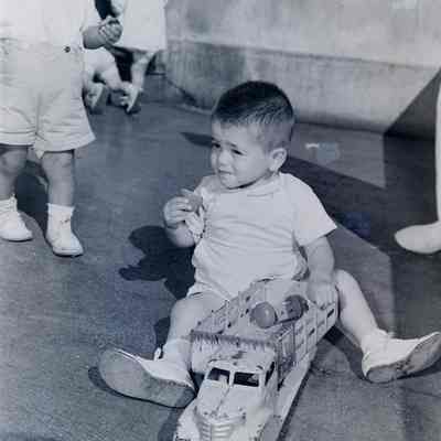 Japanese boy playing with a toy truck