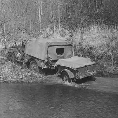 Truck and trailer fording a stream