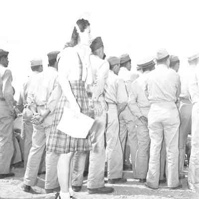 Woman looking over a crowd of soldiers