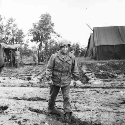 Soldier walking through deep mud