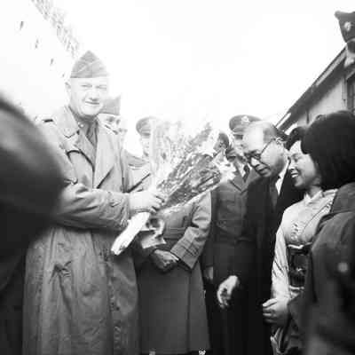 General Styron receiving flowers from a Japanese delegation at pier