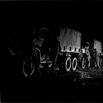 Soldiers standing next to trucks
