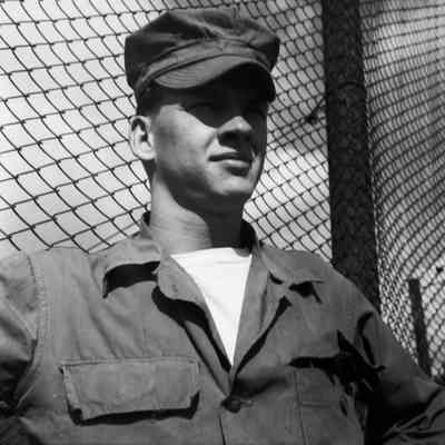 Soldier in front of a fence