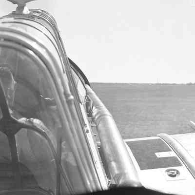 View of a grassy field from the cockpit of an aircraft