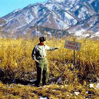 Soldier pointing to a sign