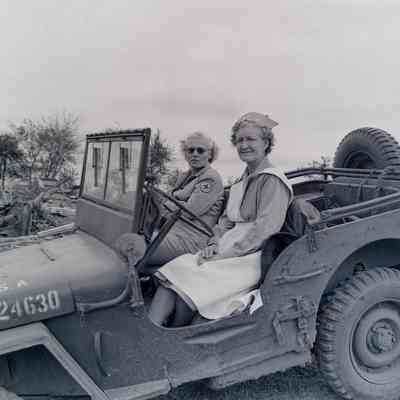 Nurses sitting in a jeep