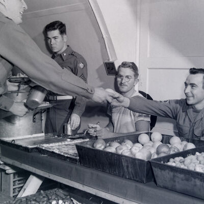 Troops going through chow line in a mess hall