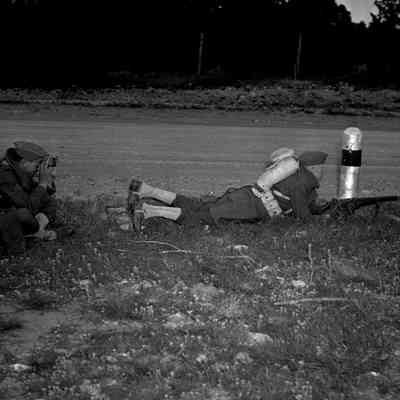Soldier beside a roadway with spotter behind