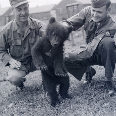 Two soldiers with a bear cub