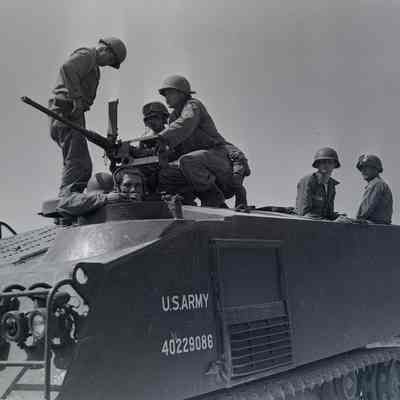 Soldiers and crew on an M-75 armored personnel carrier