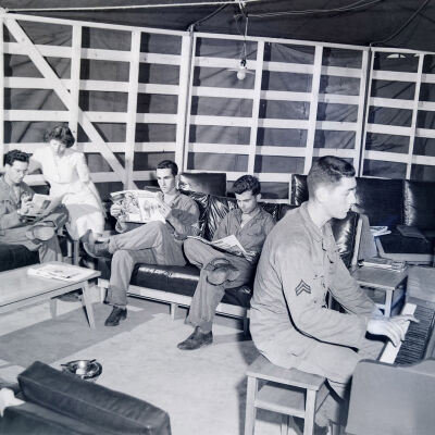 Soldiers and an Army Service Corps female relaxing